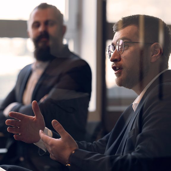 Man talking to a group around a table