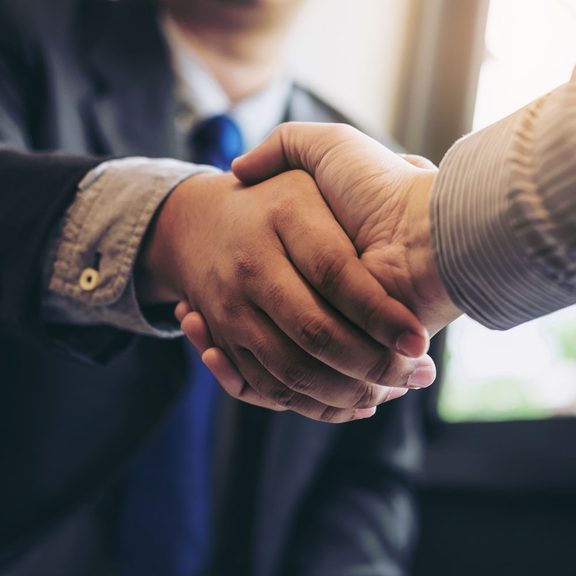 A close up of two people shaking hands