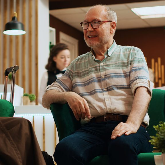 Older Man sitting in a Lobby