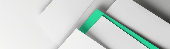 One green sheet of paper among several white sheets