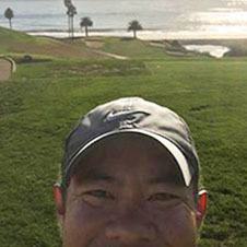 Photo of the top of a persons head and the ocean