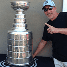 Photo of a person next to a large trophy