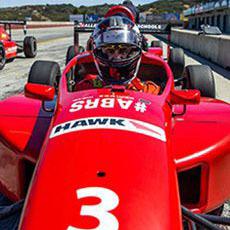 Photo of a person in a stock racing car
