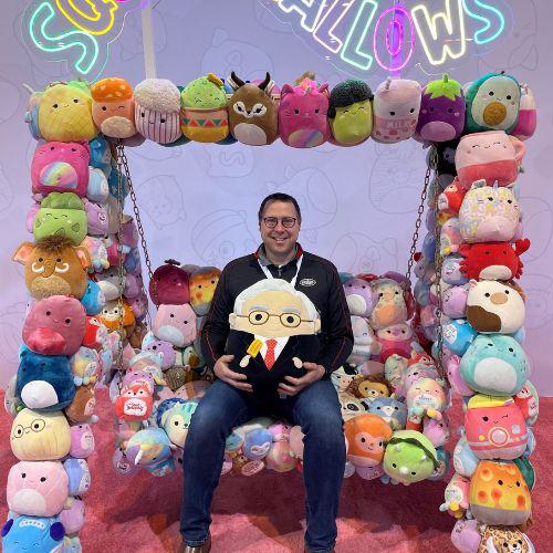 Photo of a man and multiple stuffed animals