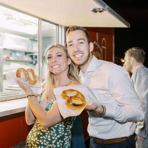 Photo of two people with pretzels