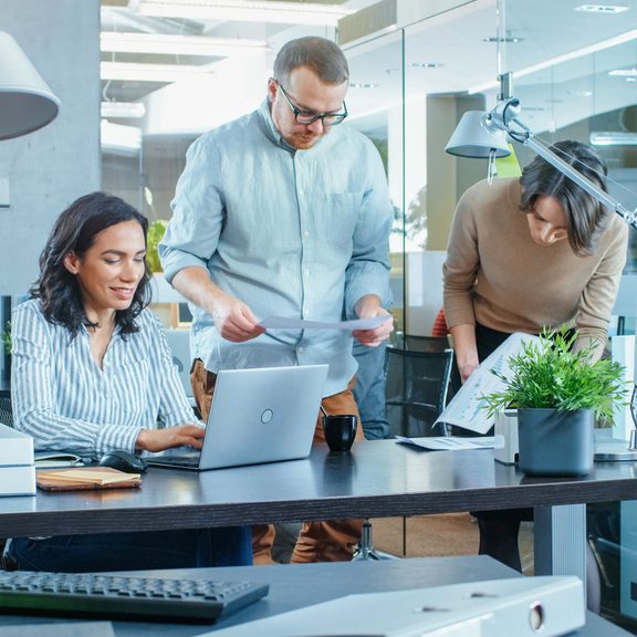 Three office colleagues working as a team