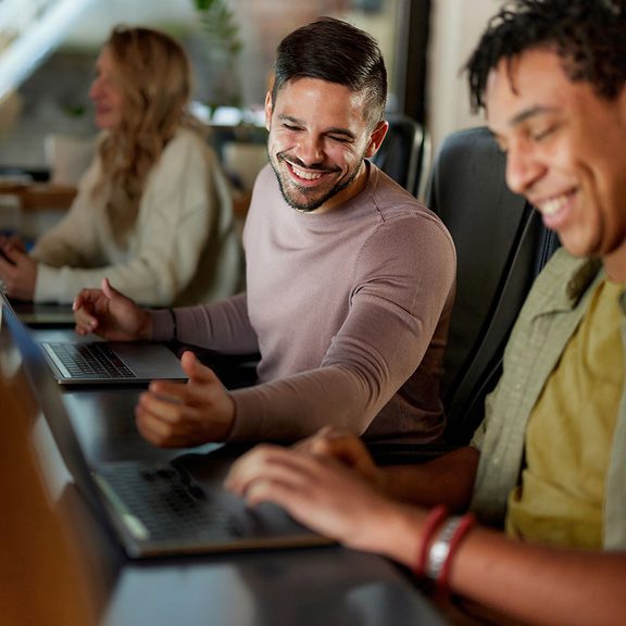 Two men working together in a conference room