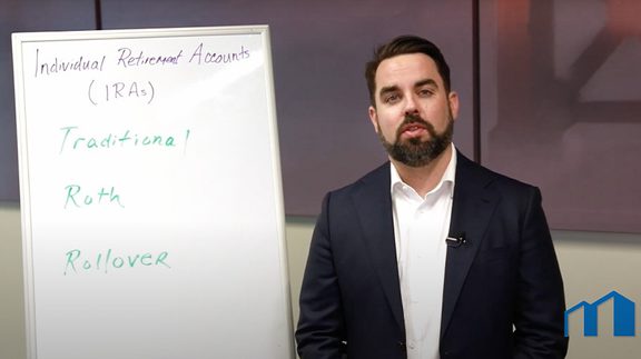 Man talking in front of a white board