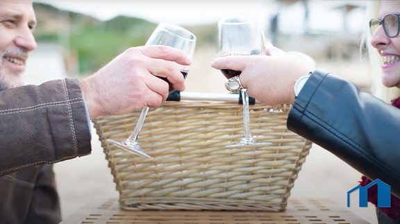 two people clinking wine glasses
